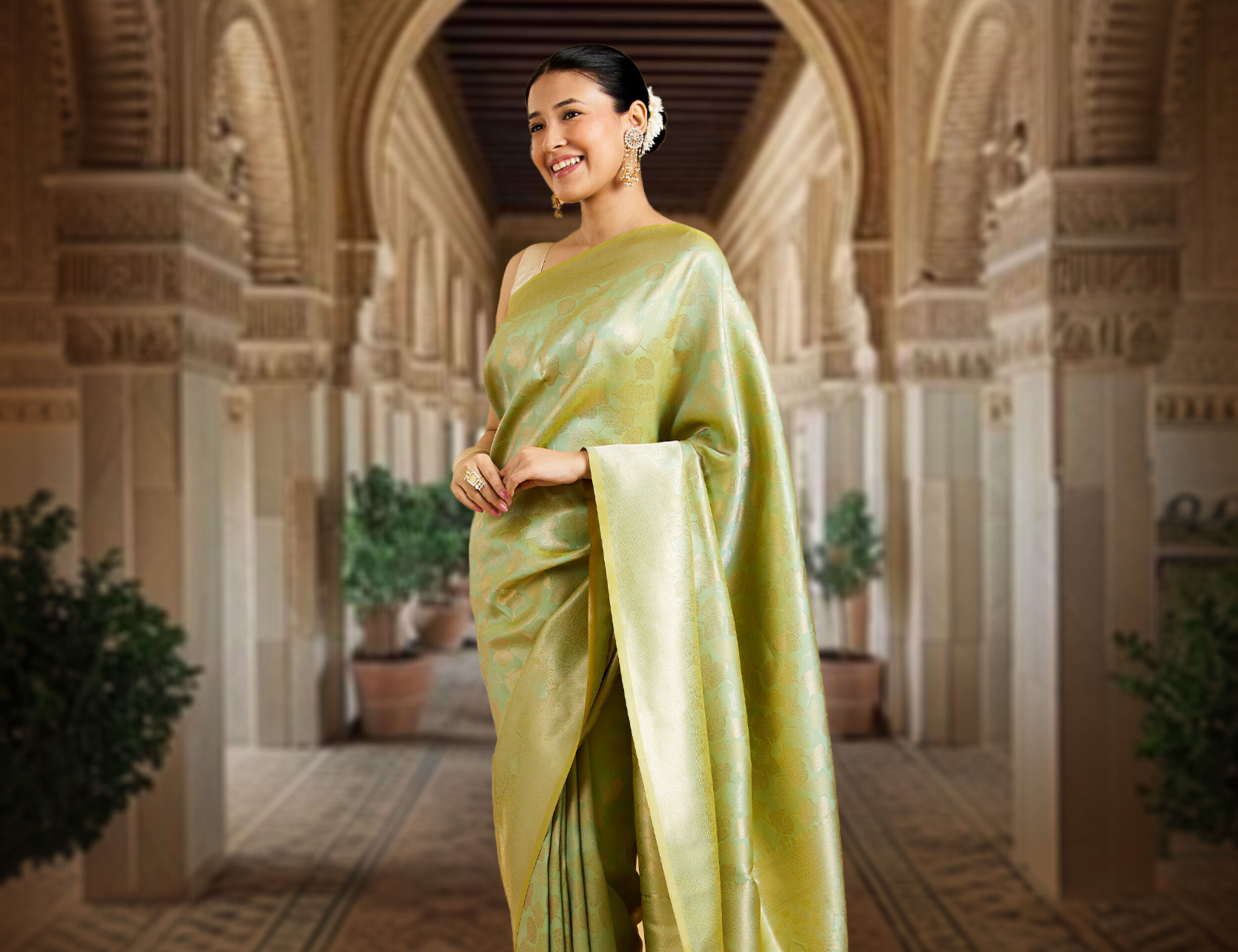 A woman wearing a zari work saree with jewellery